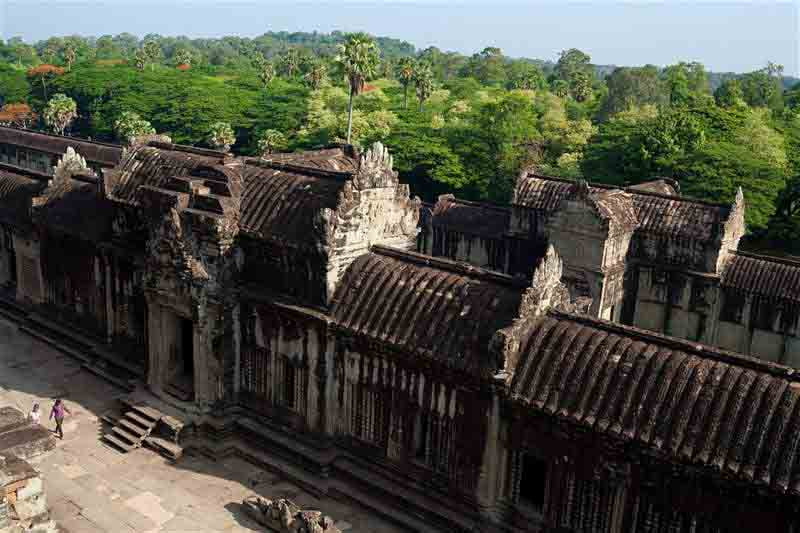 A section of the outer wall at Angkor Wat with thick jungle in the background